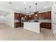 An open concept kitchen with stainless steel appliances, center island, and lots of cabinetry at 5064 Meadow Song Dr, Okahumpka, FL 34762