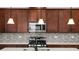 A beautifully appointed kitchen featuring stainless steel appliances and stylish pendant lighting at 5064 Meadow Song Dr, Okahumpka, FL 34762