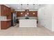 Kitchen boasts an island, stainless steel appliances, and ample cabinet space at 5064 Meadow Song Dr, Okahumpka, FL 34762