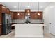 Kitchen features a spacious island, stainless appliances, and modern pendant lighting at 5064 Meadow Song Dr, Okahumpka, FL 34762