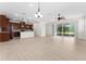 The open-concept kitchen seamlessly flows into the living area with a view of the lanai at 5064 Meadow Song Dr, Okahumpka, FL 34762