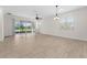 An airy living room features access to an outdoor lanai with large sliding glass doors at 5064 Meadow Song Dr, Okahumpka, FL 34762