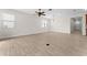 An expansive living room boasts contemporary tile flooring, bright lighting, and lots of space at 5064 Meadow Song Dr, Okahumpka, FL 34762