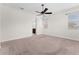 Spacious main bedroom includes neutral carpet, ceiling fan, and an ensuite bathroom at 5064 Meadow Song Dr, Okahumpka, FL 34762