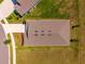 Aerial view showcases the roof of a single Gathering home surrounded by green landscaping at 5064 Meadow Song Dr, Okahumpka, FL 34762