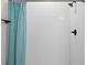 Walk-in shower with white subway tiles, a matte black shower head, and a blue shower curtain at 5064 Meadow Song Dr, Okahumpka, FL 34762