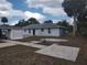 Backyard showing the house, patio, and palm trees at 540 W Mathis Ave, Deland, FL 32720