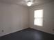 This is a bedroom with neutral decor, has a ceiling fan, and a window at 540 W Mathis Ave, Deland, FL 32720
