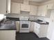 Well lit kitchen featuring white cabinets, countertops and essential appliances at 540 W Mathis Ave, Deland, FL 32720