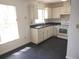 This kitchen is equipped with white cabinets, countertops, and essential appliances at 540 W Mathis Ave, Deland, FL 32720