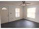 Bright living room featuring a ceiling fan, two windows and a white front door for a cozy atmosphere at 540 W Mathis Ave, Deland, FL 32720