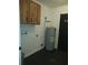 Utility room with an indoor water heater and overhead cabinets at 540 W Mathis Ave, Deland, FL 32720