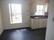 Bright kitchen with white cabinets, black countertops and modern sink at 540 W Mathis Ave, Deland, FL 32720