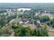 Aerial perspective of property, highlighting home, outbuildings, and surrounding lush greenery at 5410 Deleon Springs Ranch Rd, De Leon Springs, FL 32130