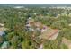Aerial view of property with red property lines surrounded by green, mature trees and roadways at 5410 Deleon Springs Ranch Rd, De Leon Springs, FL 32130