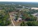 Aerial view of property with red property lines surrounded by green, mature trees and roadways at 5410 Deleon Springs Ranch Rd, De Leon Springs, FL 32130