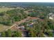 Aerial view of property with red property lines surrounded by green, mature trees and roadways at 5410 Deleon Springs Ranch Rd, De Leon Springs, FL 32130