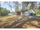 Spacious backyard featuring a screened porch, a shed, and mature trees offering ample shade at 5410 Deleon Springs Ranch Rd, De Leon Springs, FL 32130