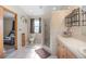 Bright bathroom featuring a shower, toilet, and vanity with a granite countertop at 5410 Deleon Springs Ranch Rd, De Leon Springs, FL 32130
