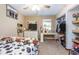 Cozy bedroom with neutral walls, a ceiling fan, a television, and a closet filled with clothing at 5410 Deleon Springs Ranch Rd, De Leon Springs, FL 32130