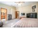 Bedroom with a ceiling fan, a mounted TV, and direct access to the bathroom and kitchen at 5410 Deleon Springs Ranch Rd, De Leon Springs, FL 32130
