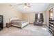 Bedroom with a ceiling fan, an accent chair, and a shoe rack at 5410 Deleon Springs Ranch Rd, De Leon Springs, FL 32130
