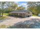 Expansive view of the single-story home, surrounded by lush greenery and a spacious yard at 5410 Deleon Springs Ranch Rd, De Leon Springs, FL 32130