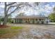 Inviting single-story home with a covered front porch and a well-maintained lawn at 5410 Deleon Springs Ranch Rd, De Leon Springs, FL 32130