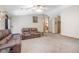 A spacious living room with carpet, a ceiling fan, and comfortable brown leather seating at 5410 Deleon Springs Ranch Rd, De Leon Springs, FL 32130