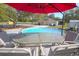 Backyard featuring an above-ground pool, table and chairs for relaxing, with a home in the background at 5410 Deleon Springs Ranch Rd, De Leon Springs, FL 32130