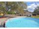 Backyard featuring an above-ground pool with deck and view of the single-story home at 5410 Deleon Springs Ranch Rd, De Leon Springs, FL 32130