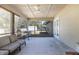 Spacious screened porch with wood ceilings, concrete floor and outdoor seating area at 5410 Deleon Springs Ranch Rd, De Leon Springs, FL 32130