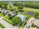 Aerial view of a house near ponds and a golf course at 5479 Saint Regis Way, Port Orange, FL 32128