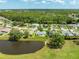 A vibrant community with a mix of homes, lush landscaping, and a peaceful pond at 5479 Saint Regis Way, Port Orange, FL 32128
