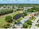 A charming neighborhood featuring homes, a golf course, and a scenic pond from above at 5479 Saint Regis Way, Port Orange, FL 32128