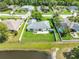 Aerial view of a home with a well-maintained lawn, patio, and surrounding fence for added privacy at 5479 Saint Regis Way, Port Orange, FL 32128