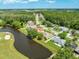 Scenic aerial view of homes along a pond, surrounded by lush trees and a golf course at 5479 Saint Regis Way, Port Orange, FL 32128