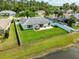 A serene backyard featuring a well-maintained lawn, white fence, and a glimpse of the nearby pond at 5479 Saint Regis Way, Port Orange, FL 32128