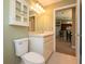 Bathroom featuring a sink, toilet and doorway to other rooms at 5479 Saint Regis Way, Port Orange, FL 32128