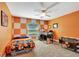 Unique bedroom with bright orange walls, drop ceiling, and large window view of the outdoors at 5479 Saint Regis Way, Port Orange, FL 32128