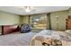 Bright bedroom features a ceiling fan, comfy chair and a relaxing view of the outdoors at 5479 Saint Regis Way, Port Orange, FL 32128