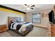 Comfortable bedroom featuring great natural light, ceiling fan, and neutral colored carpeting at 5479 Saint Regis Way, Port Orange, FL 32128