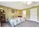 Cozy bedroom with neutral carpeting with easy access to a nearby bathroom at 5479 Saint Regis Way, Port Orange, FL 32128