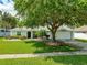 Single-story home with a well-manicured lawn and mature trees at 5479 Saint Regis Way, Port Orange, FL 32128