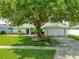 Charming single-story home with well-manicured lawn and mature trees at 5479 Saint Regis Way, Port Orange, FL 32128