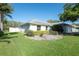 Charming single-story home features well-maintained landscaping and a freshly manicured green lawn at 5479 Saint Regis Way, Port Orange, FL 32128