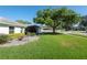 Well-manicured lawn and mature tree enhance this charming home's curb appeal in a lovely neighborhood at 5479 Saint Regis Way, Port Orange, FL 32128