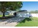 Attached two-car garage with a wide driveway and a manicured lawn for added curb appeal at 5479 Saint Regis Way, Port Orange, FL 32128