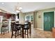 Cozy kitchen and dining area featuring dark wood cabinets, tile floors, and a window providing natural light at 5479 Saint Regis Way, Port Orange, FL 32128