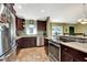 Spacious kitchen with stainless steel appliances and granite countertops open to the dining area at 5479 Saint Regis Way, Port Orange, FL 32128